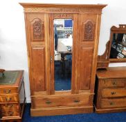 A c.1900 walnut wardrobe with centre mirror & carv