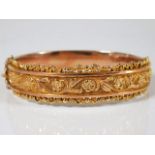 An antique decorative 9ct two tone rose gold bangl