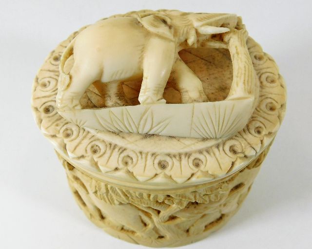 A c.1920 carved ivory box depicting elephant on li