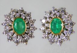 A pair of 14ct gold earrings set with emeralds & a