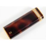 A Cartier lighter with faux tortoiseshell finish i