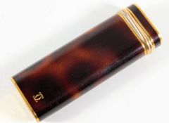 A Cartier lighter with faux tortoiseshell finish i