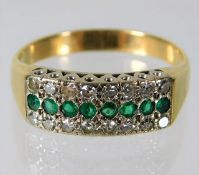 An 18ct gold ring set with diamonds & emeralds 5.1