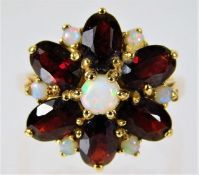 A 14ct gold ring set with garnet & opal 5g size M