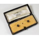 A boxed pair of 14ct gold collar studs with white