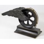 A desk thermometer mounted on bronze winged wheel