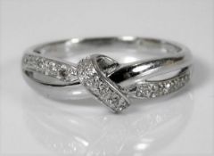 A 9ct white gold crossover ring set with diamonds