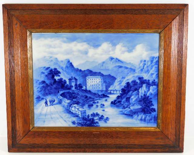 A 19thC. blue & white porcelain plaque depicting Medmenham set in oak frame 18.75in wide x 15.625in