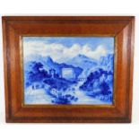 A 19thC. blue & white porcelain plaque depicting Medmenham set in oak frame 18.75in wide x 15.625in