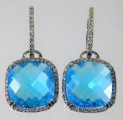 A pair of 14ct gold blue topaz earrings set with a