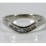 A 9ct white gold wishbone style ring set with diam