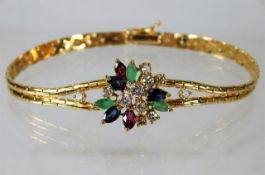 An 18ct gold bracelet set with emerald, ruby, sapp