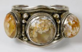 A silver bangle set with agate type stone