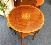 An Edwardian mahogany table with inlaid decor & bo