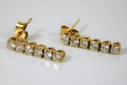 A pair of yellow metal earrings set with approx. 1