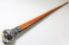 A malacca cane with embossed Chinese white metal knop 34.5in