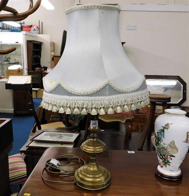 A decorative brass lamp with shade