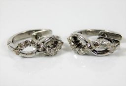 An 18ct white gold pair of earrings set with appro