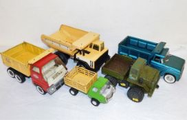 Three Tonka trucks, a Meccano Truck and one other