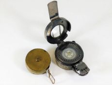 A brass pig measuring tape and a compass TG Co Ltd