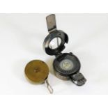 A brass pig measuring tape and a compass TG Co Ltd