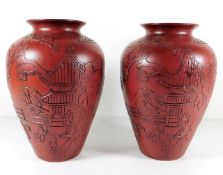 A pair of Chinese vases with relief decor 10.25in