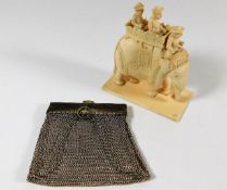 A c.1900 carved ivory elephant with figures twinned with mesh purse