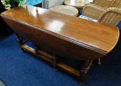 A mahogany drop leaf table in style of wake table