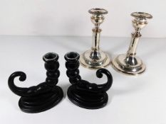 A pair of silver plate on copper candlesticks twinned one other pair