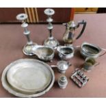 A pair of silver plated candlesticks twinned with