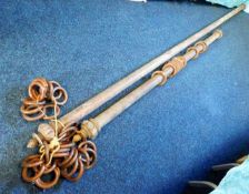 Two large curtain poles with rings