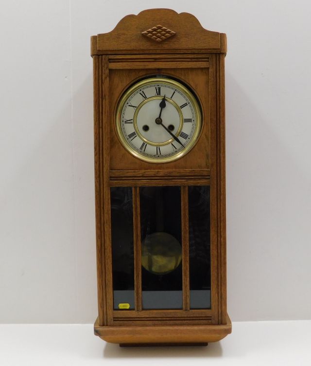 An oak cased wall clock