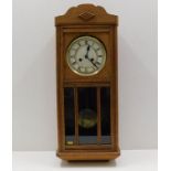 An oak cased wall clock