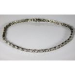 A white gold necklace, tests as 18ct, set with approx. 3ct diamonds 15in long 35.7g