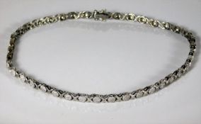 A white gold necklace, tests as 18ct, set with approx. 3ct diamonds 15in long 35.7g