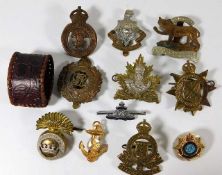 A quantity of military cap badges