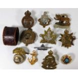 A quantity of military cap badges