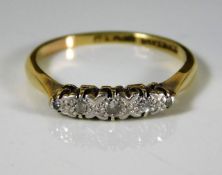 An 18ct gold ring set with platinum mounted diamon