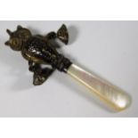 An antique silver & mother of pearl babies rattle,