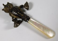 An antique silver & mother of pearl babies rattle,