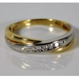 A 9ct two colour gold ring set with 0.15ct diamond