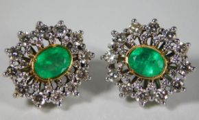 A 14ct gold pair of earrings set with approx. 2ct diamond & emeralds 12.8g