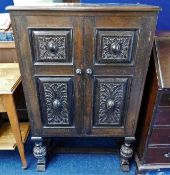 An antique style oak cupboard with relief decor do