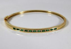 A 10ct gold bangle set with emerald & 0.2ct diamon