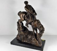 A bronze resin style model of horse & rider on pli