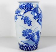 A Chinese porcelain vase with bird & foliage decor