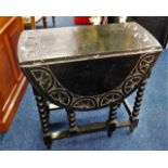 An ebonised oak drop leaf table