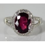 A 9ct white gold ring set with garnet & 0.375ct di