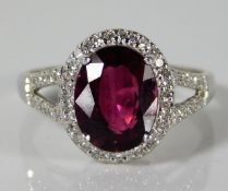 A 9ct white gold ring set with garnet & 0.375ct di