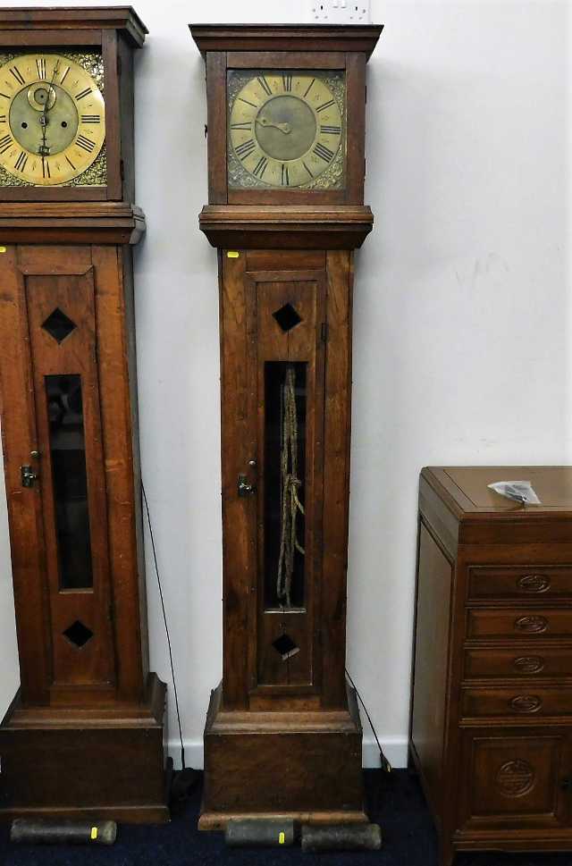 A brass faced longcase clock with rustic arts & cr